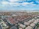 Extensive aerial view of a community featuring consistent rooftops and desert landscaping with distant mountains at 2305 W Horizon Ridge Pkwy # 322, Henderson, NV 89052