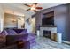 Modern living room with a stone fireplace, ceiling fan, recessed lighting and plush purple seating at 2305 W Horizon Ridge Pkwy # 322, Henderson, NV 89052