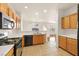 Modern kitchen with stainless steel appliances, wooden cabinets, and tiled flooring at 232 Charitable Ct, North Las Vegas, NV 89032