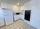 Well-lit kitchen with white cabinetry, tile flooring, and modern appliances at 233 Pecos Way, Las Vegas, NV 89121