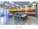 Bright arts and crafts room with ample table space, storage cabinets, and natural light from large windows at 2475 Hamonah Dr, Henderson, NV 89044