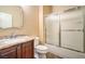 Bathroom featuring shower over tub with glass doors and granite countertops at 2475 Hamonah Dr, Henderson, NV 89044