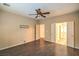 A bright bedroom with hardwood floors with an en-suite bathroom and multiple doors at 2475 Hamonah Dr, Henderson, NV 89044