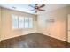 Bedroom with hardwood floors, a ceiling fan, and a window with white shutters at 2475 Hamonah Dr, Henderson, NV 89044