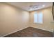 Bedroom featuring a ceiling fan, hardwood floors, and plantation shutters at 2475 Hamonah Dr, Henderson, NV 89044