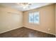 Bedroom with hardwood floors, ceiling fan, and plantation shutters at 2475 Hamonah Dr, Henderson, NV 89044