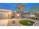 Beautiful single-story house featuring well-maintained landscaping with rock and a lovely patch of lawn at 2475 Hamonah Dr, Henderson, NV 89044