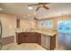 Spacious open kitchen featuring stainless steel appliances, hardwood floors, granite counters, and dark cabinets at 2475 Hamonah Dr, Henderson, NV 89044