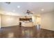 Spacious open-concept living room with hardwood floors and view into the kitchen area at 2475 Hamonah Dr, Henderson, NV 89044