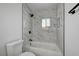 Bathroom features tile lined shower with tub combination and a window at 2512 Taylor Ave, North Las Vegas, NV 89030