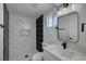 Stylishly updated bathroom featuring new fixtures, decorative mirror, and black and white tile at 2512 Taylor Ave, North Las Vegas, NV 89030