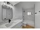 Modern bathroom with a sink and marble tile bathtub and shower at 2512 Taylor Ave, North Las Vegas, NV 89030