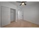Bedroom with neutral carpet, closet, ceiling fan, and entrance to another room at 2512 Taylor Ave, North Las Vegas, NV 89030