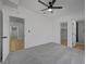 Bright bedroom with soft carpet, ceiling fan, and ensuite bathroom at 2512 Taylor Ave, North Las Vegas, NV 89030