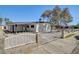 Front exterior showcasing the manicured xeriscaping and a white picket fence enclosing the property at 2512 Taylor Ave, North Las Vegas, NV 89030
