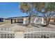 Charming single-story home featuring xeriscaping, mature trees, and a covered parking area at 2512 Taylor Ave, North Las Vegas, NV 89030