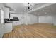 Bright living room with an open floor plan, featuring wood floors and modern lighting fixtures at 2512 Taylor Ave, North Las Vegas, NV 89030