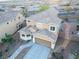 Aerial view of a two-story house with a neutral-colored exterior, tile roof, and desert landscaping at 2681 Benton Cove St, Laughlin, NV 89029