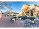 Backyard featuring desert landscaping, seating area, small bridge, and home exterior at 2681 Benton Cove St, Laughlin, NV 89029