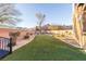 Landscaped backyard featuring artificial turf, desert landscaping, and a small bridge at 2681 Benton Cove St, Laughlin, NV 89029