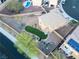 Aerial view of a spacious backyard featuring a pool, lush lawn, and desert landscaping at 2681 Benton Cove St, Laughlin, NV 89029