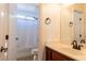 Bright bathroom features a shower-tub combo and vanity with dark wood cabinetry at 2681 Benton Cove St, Laughlin, NV 89029