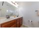 Bathroom with double sink vanity, framed mirrors, and a decorative lighting fixture at 2681 Benton Cove St, Laughlin, NV 89029