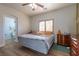 Comfortable bedroom includes wood floors, a ceiling fan, and neutral paint scheme at 2681 Benton Cove St, Laughlin, NV 89029