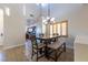 Bright dining room featuring an elegant chandelier and a view of the open kitchen at 2681 Benton Cove St, Laughlin, NV 89029