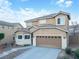 Inviting two-story home with a charming exterior, attached garage, and well-kept landscaping at 2681 Benton Cove St, Laughlin, NV 89029