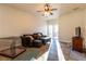 Relaxing living room featuring wood flooring, a ceiling fan, and a sliding glass door to the backyard at 2681 Benton Cove St, Laughlin, NV 89029