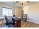 A home office features a modern chair, desk and a window providing natural lighting at 2681 Benton Cove St, Laughlin, NV 89029