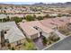 An aerial view shows a well-maintained home with a tile roof and beautiful desert landscaping at 2765 Struan, Henderson, NV 89044