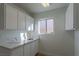 Laundry room with cabinets, marble countertops, and a utility sink at 2824 Morning Ridge Dr, Las Vegas, NV 89134