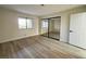 Bright bedroom featuring wood-look floors, natural light, and sliding door closet at 2899 Bluebonnet Dr # 2899, Henderson, NV 89074