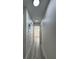 Bright hallway featuring updated lighting, neutral walls and wood-look floors at 2899 Bluebonnet Dr # 2899, Henderson, NV 89074