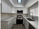 Bright kitchen features stainless steel appliances, white cabinets, and stone countertops at 2899 Bluebonnet Dr # 2899, Henderson, NV 89074