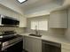 Updated kitchen with stainless steel appliances, white cabinets, and modern faucet at 2899 Bluebonnet Dr # 2899, Henderson, NV 89074