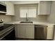 Updated kitchen featuring stainless steel appliances, sink and white cabinetry at 2899 Bluebonnet Dr # 2899, Henderson, NV 89074