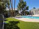 Community pool with well-maintained deck and lush landscaping in a tranquil setting at 2899 Bluebonnet Dr # 2899, Henderson, NV 89074