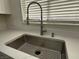 Close up of a stainless steel kitchen sink with stone countertop at 2899 Bluebonnet Dr # 2899, Henderson, NV 89074
