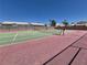 Outdoor tennis court with vibrant green and red surfacing and lush surroundings at 2899 Bluebonnet Dr # 2899, Henderson, NV 89074