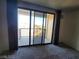 Bedroom view to outdoor balcony with sliding glass doors and neutral colored walls at 29 Montelago Blvd # 336, Henderson, NV 89011