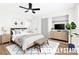 This staged bedroom offers a calming space, with a bed, side tables, and a TV with storage at 304 Orland St # 43, Las Vegas, NV 89107