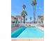 A refreshing pool is surrounded by white fences and palm trees under a clear blue sky at 304 Orland St # 43, Las Vegas, NV 89107