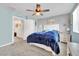 Comfortable bedroom featuring carpet flooring, ceiling fan, soothing wall colors and bright natural lighting at 310 Rain Quail Way, Henderson, NV 89012