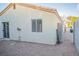 View of the house exterior with a low-maintenance backyard featuring gravel and access gate at 3236 Idaho Springs St, North Las Vegas, NV 89032