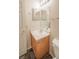 Neutral bathroom features a light wood vanity with a sink and mirrored medicine cabinet at 3236 Idaho Springs St, North Las Vegas, NV 89032
