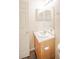 Clean half bathroom featuring a wood vanity, a sink, and a mirror at 3236 Idaho Springs St, North Las Vegas, NV 89032