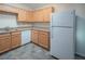 Cozy kitchen featuring light wood cabinetry and white appliances, including a dishwasher at 3236 Idaho Springs St, North Las Vegas, NV 89032